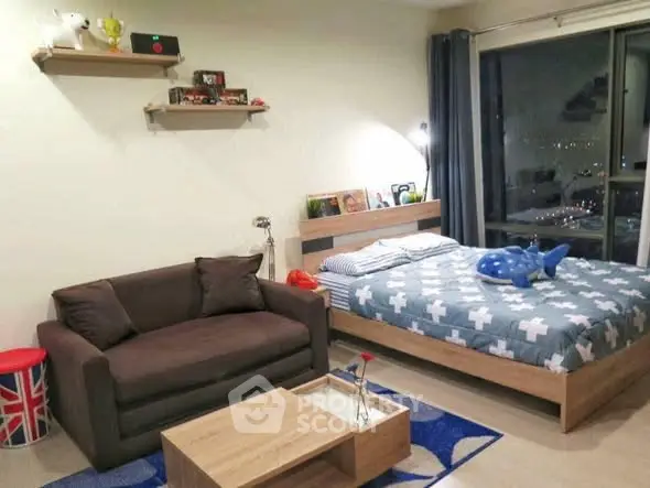 Cozy bedroom with city view, modern decor, and comfortable seating area.