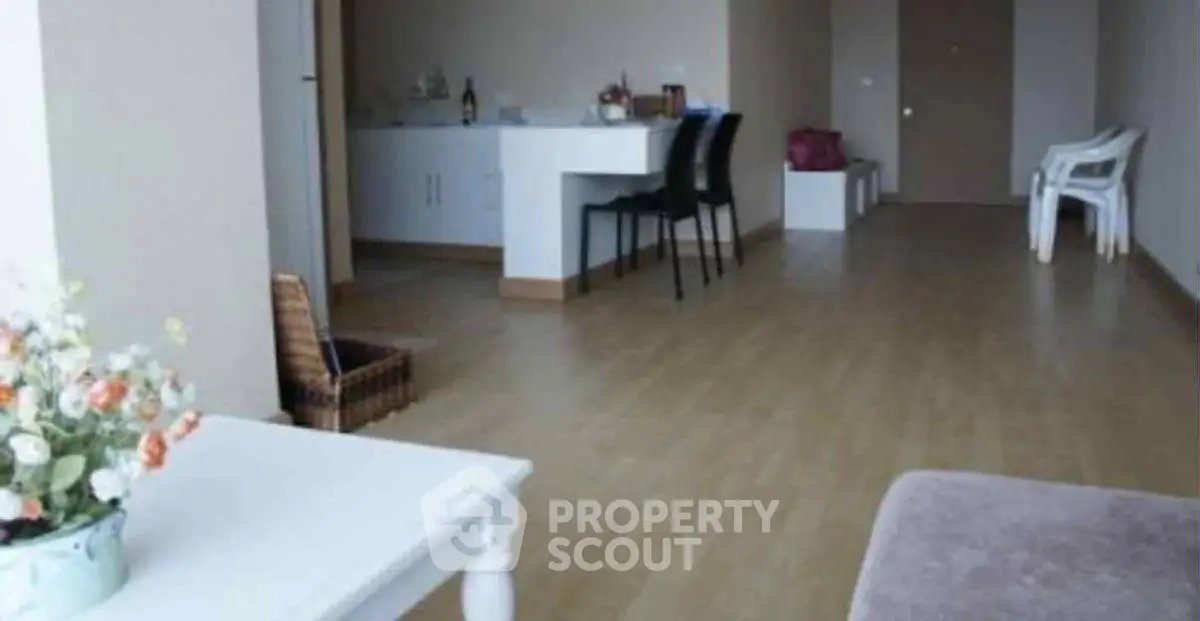 Spacious living room with modern decor and wooden flooring