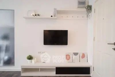 Modern minimalist living room with wall-mounted TV and stylish decor