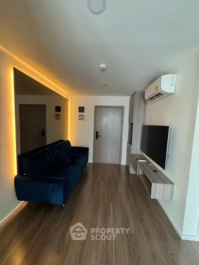 Modern living room with sleek wooden flooring and ambient lighting