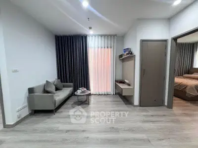 Modern living room with sleek design, featuring a cozy sofa, stylish curtains, and elegant flooring.