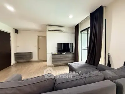 Spacious living room with modern decor and large windows for natural light.