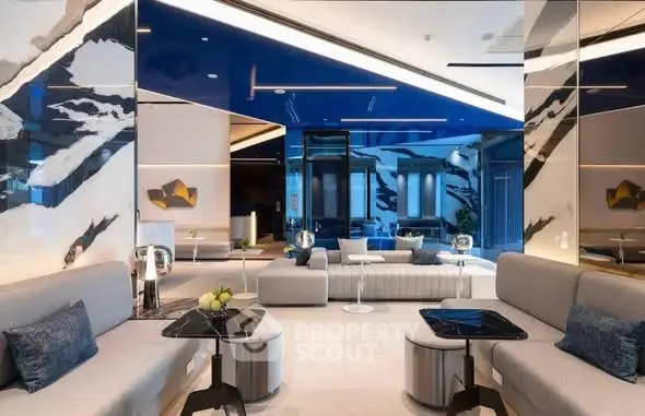 Modern living room with sleek furniture and artistic decor in luxurious apartment.