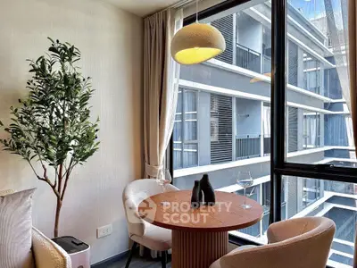 Chic modern apartment with cozy dining nook and large window view