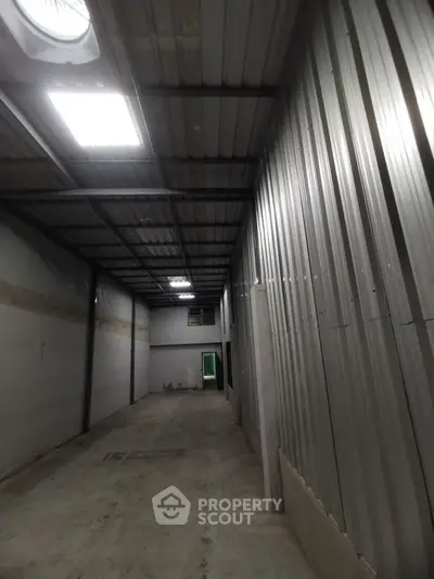 Spacious industrial warehouse interior with high ceilings and metal walls