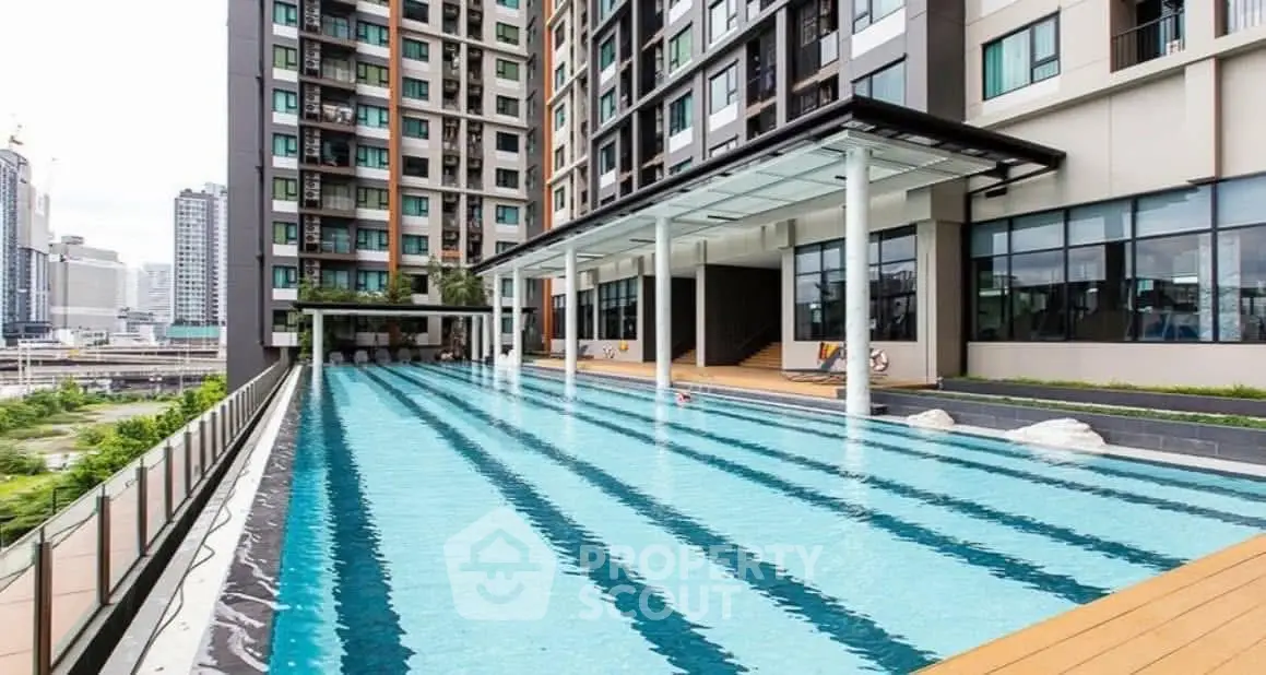 Luxurious modern apartment complex with a stunning outdoor pool and city views.