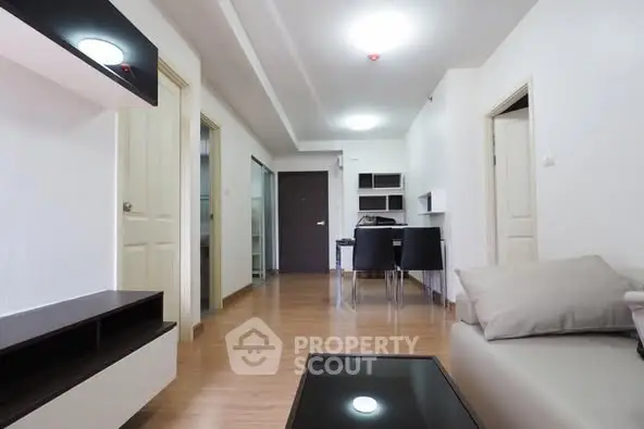 Spacious modern living room with dining area and sleek wooden flooring