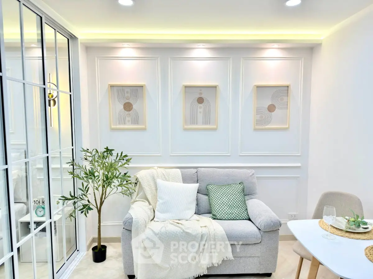Elegant living room with modern decor, cozy sofa, and stylish wall art in a bright, inviting space.