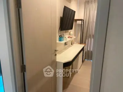 Compact study area with wall-mounted TV and modern decor