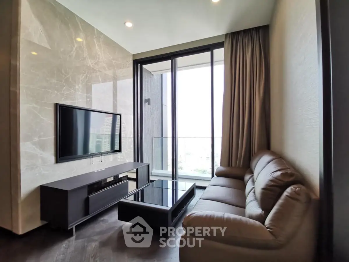 Luxurious living room with modern furniture and large windows offering a stunning view.