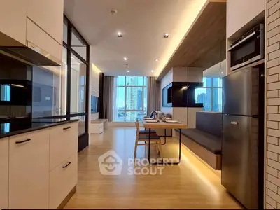 Modern open-plan kitchen and living area with sleek design and city view.