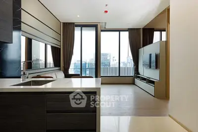 Modern open-plan living room with city view, sleek kitchen island, and floor-to-ceiling windows.