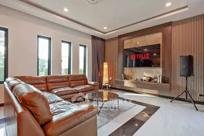 Luxurious living room with leather sofas and modern entertainment setup