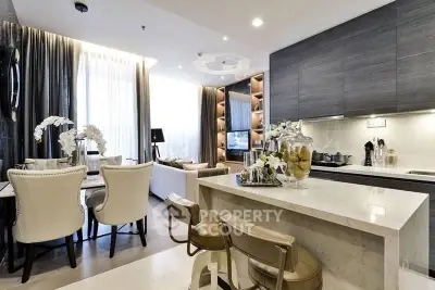 Luxurious open-layout living room and kitchen with elegant decor and modern furnishings.