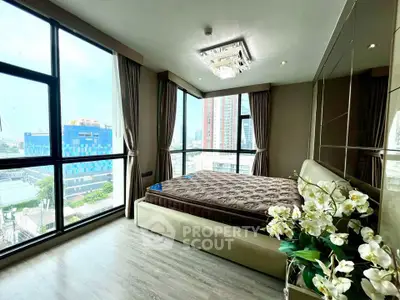 Luxurious corner bedroom with panoramic city views and elegant decor