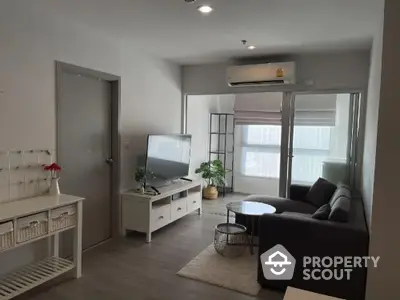 Modern living room with sleek furniture and natural light in a stylish apartment.