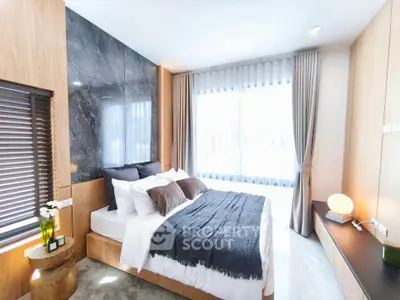 Luxurious modern bedroom with elegant decor and large windows for natural light.