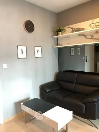 Modern living room with sleek black leather sofa and stylish decor