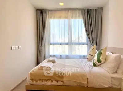 Cozy bedroom with natural light and elegant decor in modern apartment.