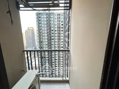 Urban balcony with cityscape view, perfect for enjoying skyline vistas in a modern high-rise building.
