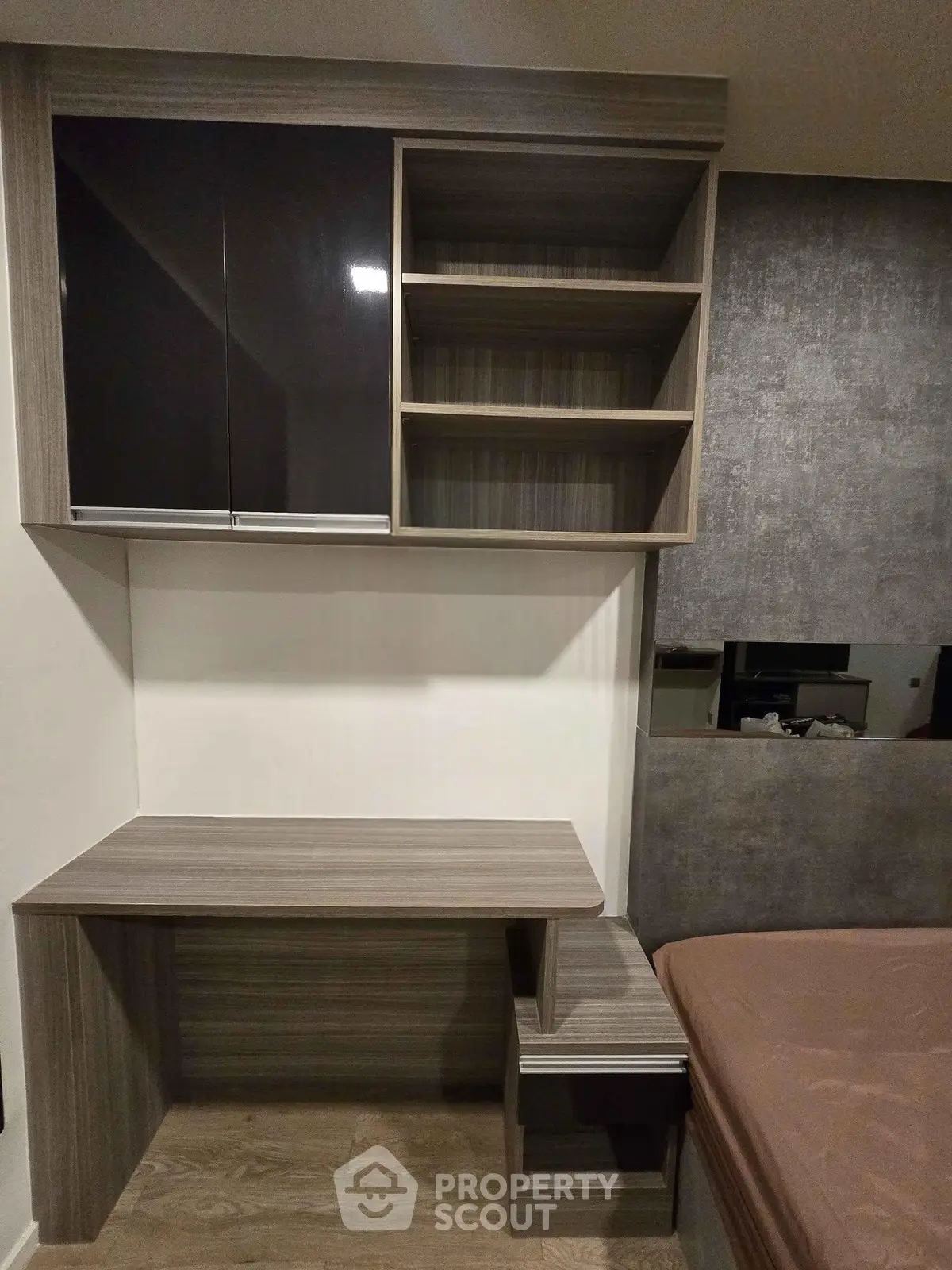 Modern bedroom with sleek built-in desk and shelving unit, perfect for maximizing space and functionality.