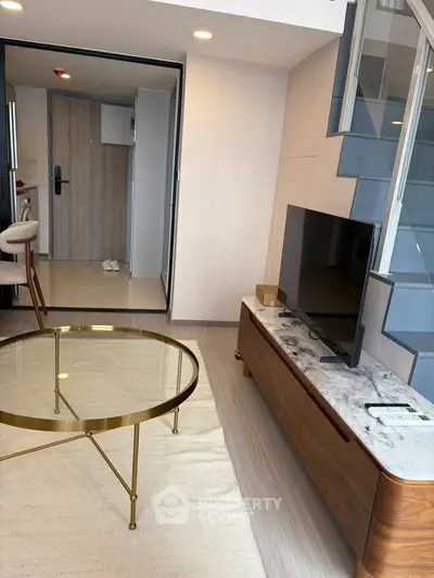 Modern living room with stylish furniture and staircase in a contemporary apartment.