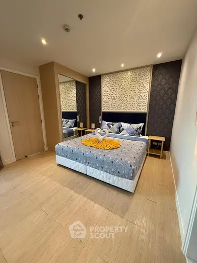 Luxurious bedroom with elegant decor and stylish bedding in modern apartment.