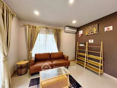 Modern living room with brown sofa, stylish decor, and ample natural light.