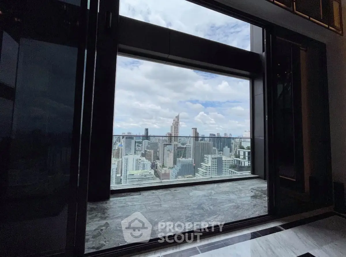 Stunning cityscape view from a high-rise building balcony with marble flooring.