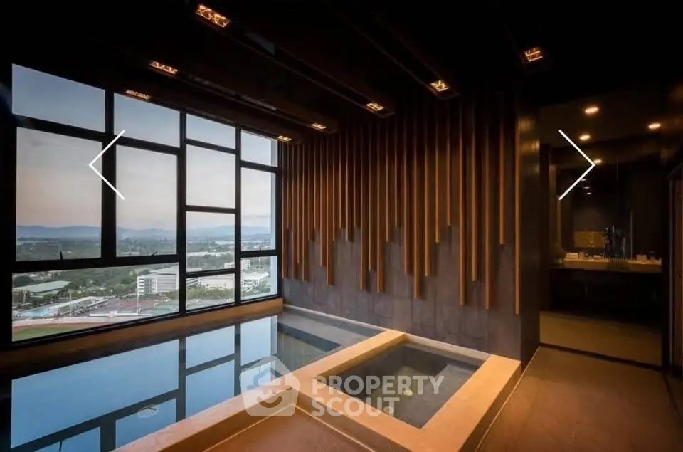 Luxurious indoor pool with stunning city view and modern design elements.