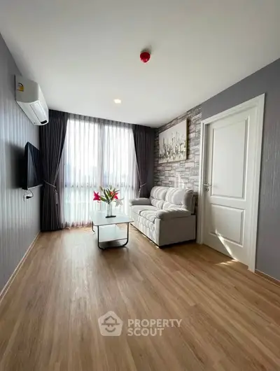 Bright and modern living room with wooden flooring and stylish decor