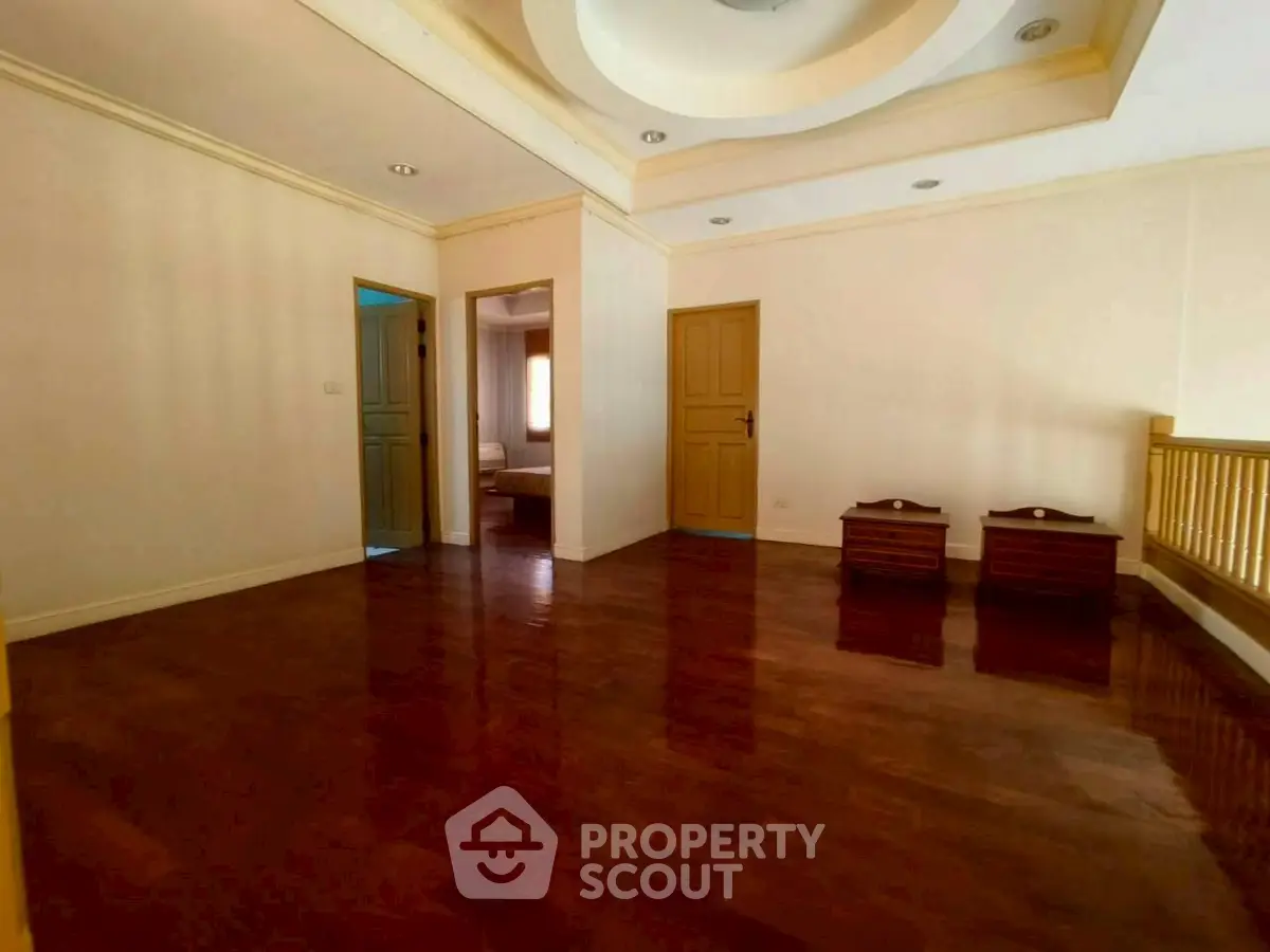 Spacious interior with polished wooden floors and elegant ceiling design