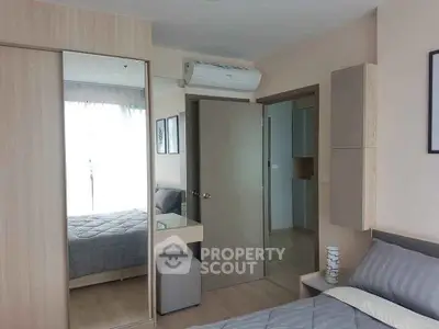 Modern bedroom with mirrored wardrobe and air conditioning in a stylish apartment.