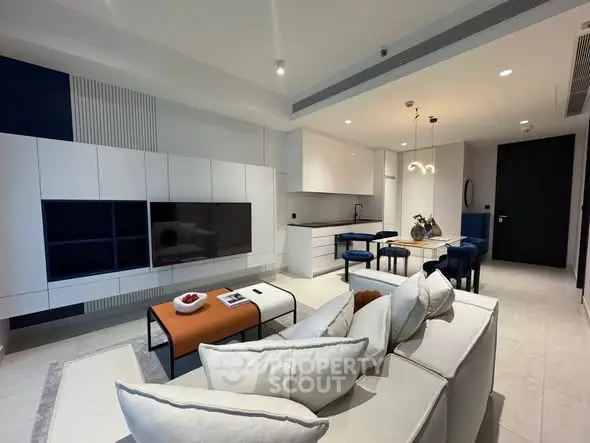 Modern living room with sleek furniture and open kitchen layout, ideal for contemporary urban living.