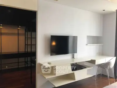 Modern living room with sleek TV setup and minimalist desk area