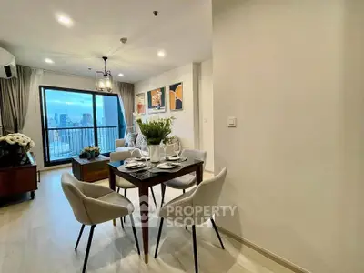 Stylish modern dining area with city view balcony in elegant apartment