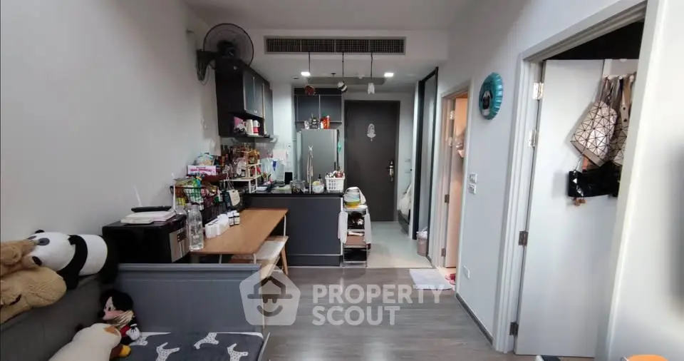 Cozy apartment interior with modern kitchen and dining area, featuring stylish decor and efficient layout.