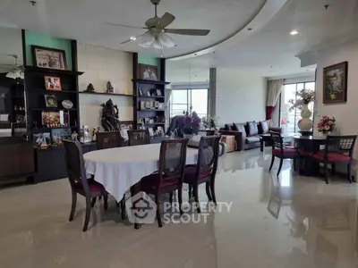 Spacious living room with elegant dining area and large windows