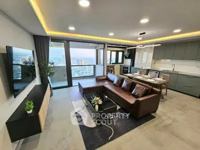 Luxurious open-plan living room with stunning city view and modern kitchen.