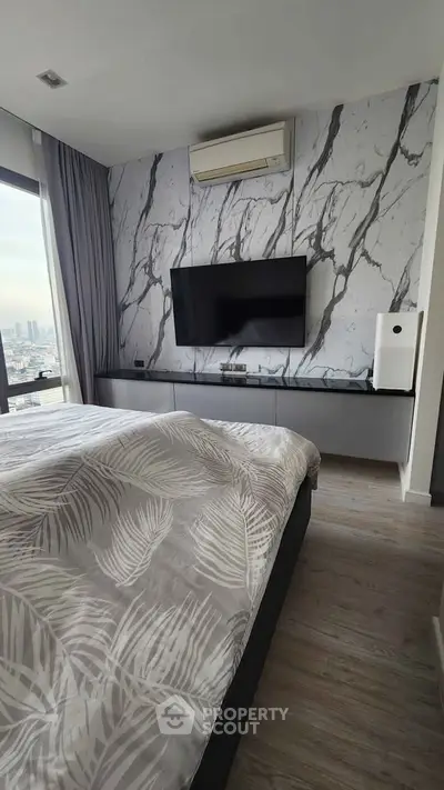 Modern bedroom with marble accent wall and city view, featuring sleek TV setup and air conditioning.