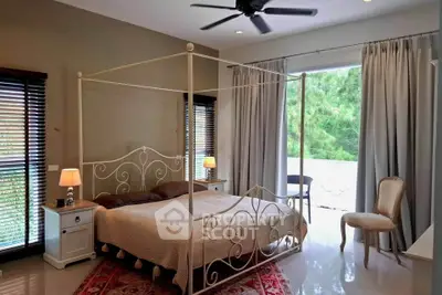 Elegant bedroom with canopy bed and large windows offering serene garden views.