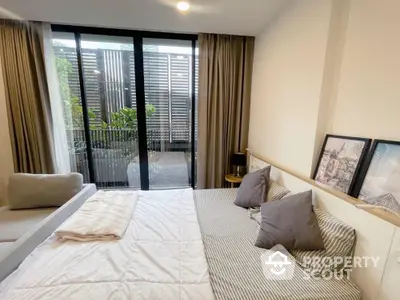 Modern bedroom with large windows and balcony access in stylish apartment