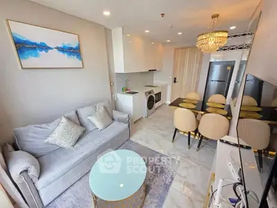 Modern living room with open kitchen, elegant decor, and stylish furniture in a cozy apartment.