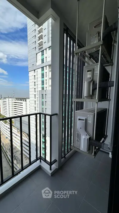 Modern high-rise balcony with city view and air conditioning units, perfect for urban living.