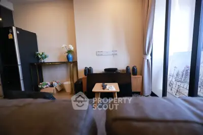 Cozy living room with modern decor and large windows offering natural light.