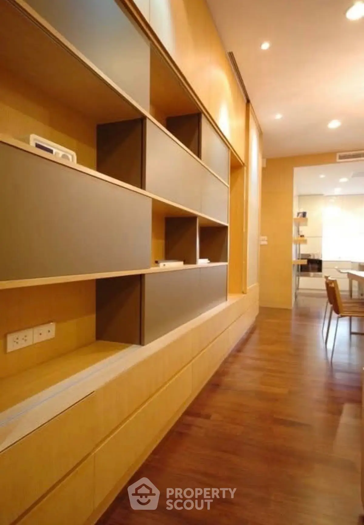 Modern study room with sleek wooden shelves and warm lighting