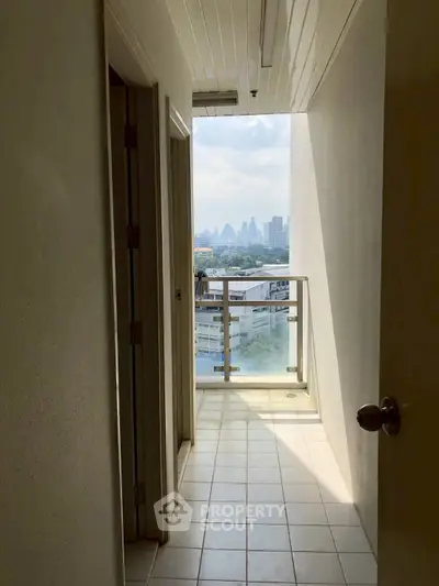 Charming corridor with city view from balcony, perfect for urban living enthusiasts.