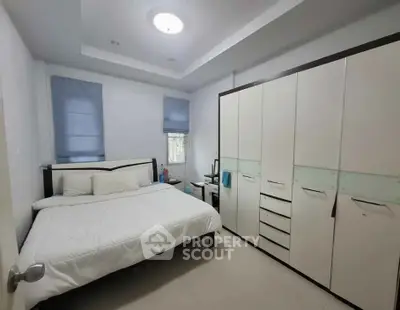 Spacious bedroom with modern furnishings and ample storage space.