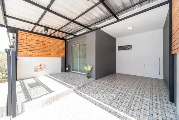 Modern covered parking area with stylish tiled flooring and wooden panel accents.