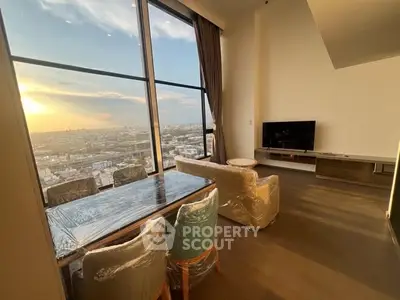 Stunning high-rise living room with panoramic city view and modern furnishings.